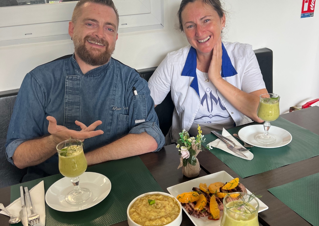 Le formateur et la participante de la formation "Connaître les bases en cuisine professionnelle" dégustent ensemble les plats préparés pendant la session, dont une soupe verte et des légumes grillés